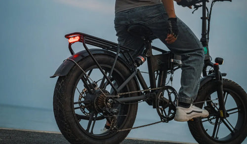 Man prepares to ride Fiido M1pro electric bicycle